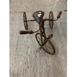 A VINTAGE WOODEN AND METAL CHILDS TRICYCLE