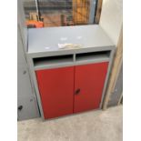 AN AS NEW RED AND GREY CABINET WITH TWO DOORS