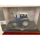 A UNIVERSAL HOBBIES DIE CAST FORD TRACTOR 1:32