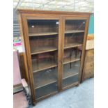 A LATE VICTORIAN OAK GLAZED TWO DOOR BOOKCASE, 48" WIDE