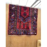 A RED PATTERNED IRANIAN RUG