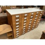 A 20TH CENTURY FORTY DRAWER HABERDASHERY CHEST, 62" WIDE, 41" HIGH AND 25" DEEP