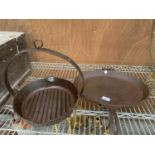 A HEAVY CAST GRIDDLE PAN AND A HEAVY CAST 'HOLCROFT' PAN