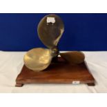 A VINTAGE BRASS PROPELLER MOUNTED ON A WOODEN BASE