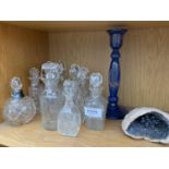 A COLLECTION OF SCENT OR VINEGAR BOTTLES AND A COBALT BLUE CANDLE STICK