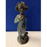 AN SPELTER EDWARDIAN STYLE FIGURINE OF A LADY AND HER DOG
