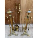 TWO DECORATIVE BRASS FIRE DOGS WITH A COMPLETE COMPANION SET
