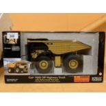 A DIECAST NORSCOT MODEL OF A CAT DUMPTRUCK IN THE BOX