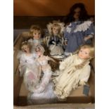 SIX PORCELAIN HEADED DOLLS OF VARIOUS SIZES TO INCLUDE A LARGE DOLL IN A BLUE AND WHITE DRESS AND