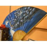 A LARGE WOOD AND PAPER DECORATIVE ORIENTAL FAN