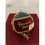 A LARGE VELVET CHRISTMAS BAUBLE WITH GOLD EMBROIDERED DETAIL 'HARRODS 2001'