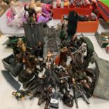 A COLLECTION OF LORD OF THE RINGS ACTION FIGURES INCLUDING HELMS DEEP AND ACCESSORIES