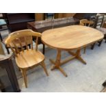 A MODERN PINE DINING TABLE AND TWO CHAIRS