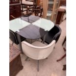 AN ART DECO STYLE GLASS TOP TABLE AND FOUR CHAIRS IN BLACK AND WHITE VINYL, ON SPLAY FEET