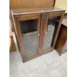 AN EARLY 20TH CENTURY TWO DOOR OAK CABINET WITH GLAZED DOORS, 36" WIDE