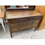 AN MAHOGANY CHEST OF TWO SHORT AND TWO LONG DRAWERS WITH CARVED SPLASHBACK