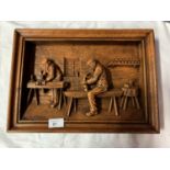 A SIGNED WOODEN CARVED PICTURE DEPICTING CARPENTERS AT WORK