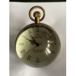 A BRASS AND GLASS BUBBLE CLOCK IN WORKING ORDER