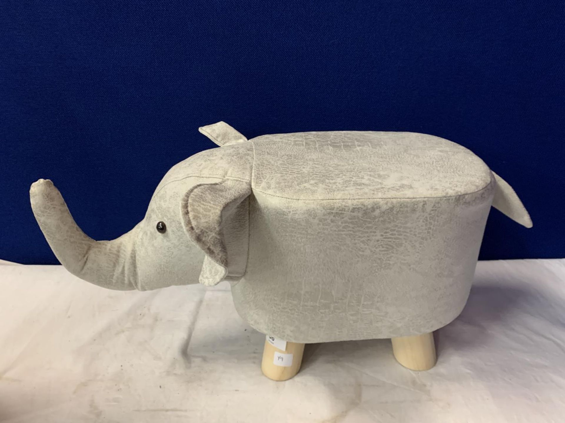 A FAUX SUEDE ELEPHANT FOOTSTOOL