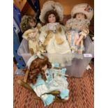 FOUR PORCELAIN HEADED DOLLS TO INCLUDE CAROLINE IN A SMALL WOODEN ROCKER