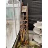A SET OF VINTAGE WOODEN STEP LADDERS AND VARIOUS GARDEN TOOLS