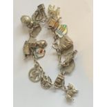 A SILVER CHARM BRACELET WITH SILVER CHARMS