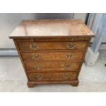 A REPRODUCTION BURR WALNUT CHEST OF FOUR GRADUATED DRAWERS WITH DRESSING SLIDE, 26" WIDE