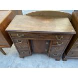 A 19TH CENTURY AND LATER MAHOGANY KNEEHOLE DESK WITH CENTRE CUPBOARD AND SEVEN DRAWERS, 31" WIDE