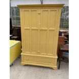 A YELLOW PAINTED WARDROBE WITH TWO DOORS AND ONE DRAWER