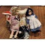 A GROUP OF FIVE PORCELAIN HEADED DOLLS