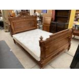 A FRENCH WALNUT 42 8" BEDSTEAD WITH FOLIATE CARVING AND TURNED SUPPORTS