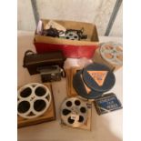 A PATHESCOPE ACE CAMERA ALONG WITH SEVERAL REELS OF FILM AND FILM MENDER