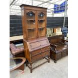 AN EARLY 20TH CENTURY OAK BUREAU BOOKCASE ON TURNED LEGS, BARLEYTWIST FRONT STRETCHER, HAVING GLAZED