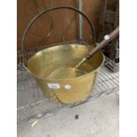 A LARGE BRASS JAM PAN AND WOODEN HANDLED BRASS STRAINER