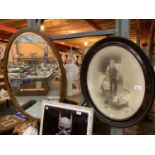 A LARGE WOODEN FRAMED OVAL MIRROR AND OVAL PORTRAIT VINTAGE PHOTOGRAPH OF MAN WITH GIRL AND HENS