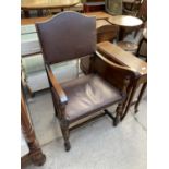 AN EARLY 20TH CENTURY OAK JACOBEAN STYLE ELBOW CHAIR WITH LEATHER AND STUDDED SEAT AND RACK