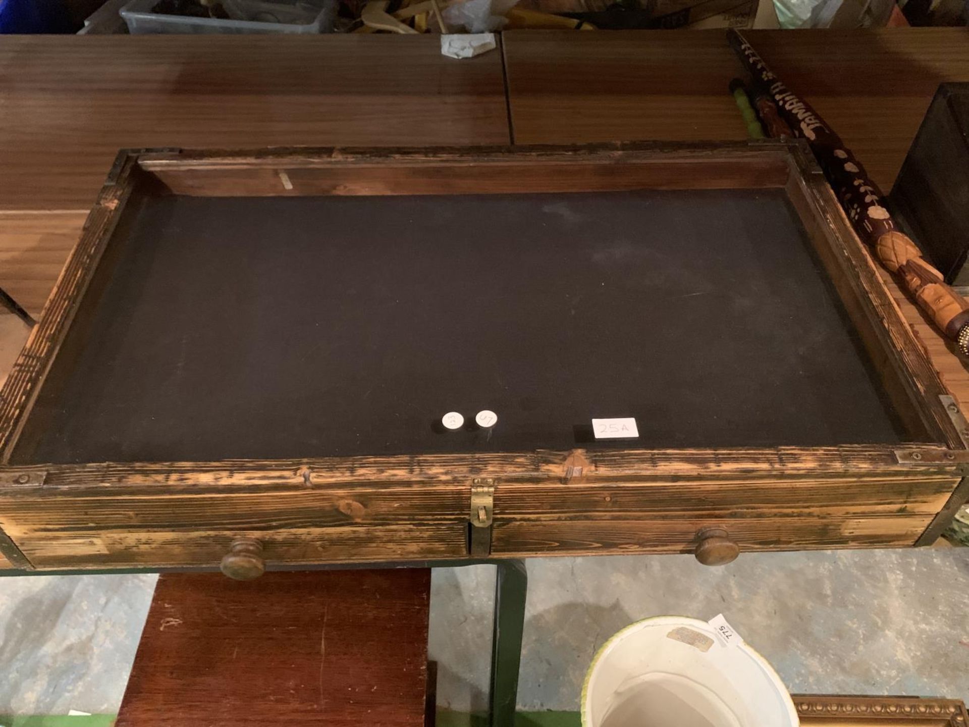 A COUNTER TOP DISPLAY CABINET WITHN GLASS TOP AND TWO DRAWERS