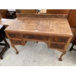 A MID 20TH CENTURY WALNUT DRESSING TABLE ON BALL AND CLAW FEET