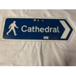 A BLUE AND WHITE METAL STREET SIGN POINTING THE WAY TO THE CATHEDRAL