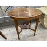 AN OVAL EDWARDIAN MAHOGANY AND INLAID TWO TIER OCCASIONAL TABLE, ON SPADE FEET, 29" WIDE