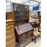 AN EARLY 20TH CENTURY OAK BUREAU BOOKCASE WITH ASTRAGAL GLAZED AND LEADED DOORS ON BARLEYTWIST FRONT