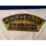 A METAL 'CHUCK'S WAGON HOT POTATOES' SIGN