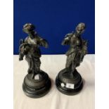 A PAIR OF SPELTER FIGURINES ON POLISHED WOODEN BASES