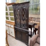 A JAYCEE OAK GLAZED AND LEADED DOUBLE CORNER CABINET, 34" WIDE