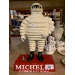 A LARGE HEAVY CAST METAL MICHELIN MAN TYRES FIGURE ON A BASE