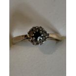 A 9 CARAT GOLD DIAMOND AND SAPPHIRE CLUSTER RING