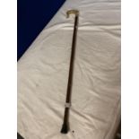 A WOODEN WALKING STICK WITH ANIMAL HORN HANDLE