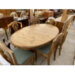 A PINE DUCAL DINING SUITE COMPRISING AN OVAL EXTENDING DINING TABLE 60x40" (CLOSED), SIX SPLAT