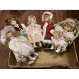 A GROUP OF FIVE ASSORTED PORCELAIN HEADED DOLLS