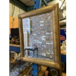 A GILT FRAMED RECTANGULAR MIRROR